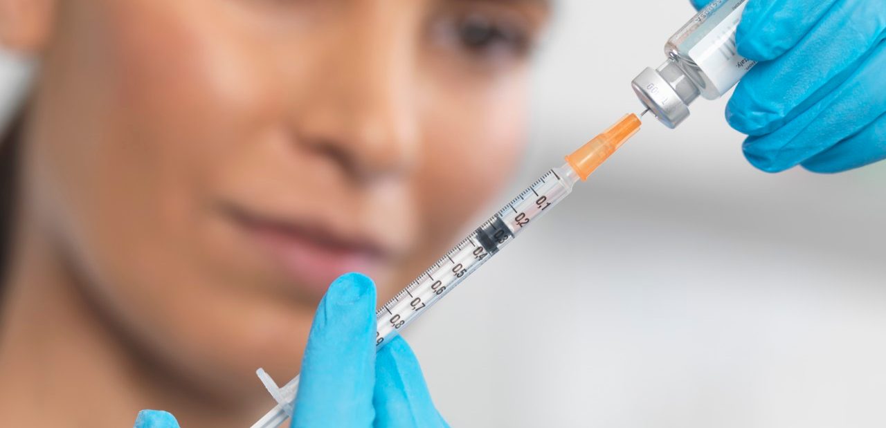 08 Feb 2014 --- Close up of nurse preparing a syringe for an injection --- Image by © Rafe Swan/Corbis