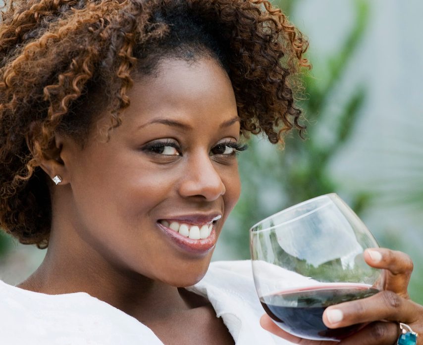 African American woman drinking red wine --- Image by © Inti St. Clair/Blend Images/Corbis