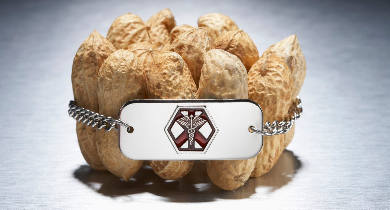 Medical alert bracelet around peanuts --- Image by © Peter Reali/Corbis