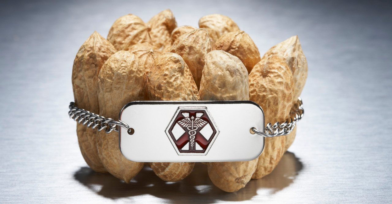 Medical alert bracelet around peanuts --- Image by © Peter Reali/Corbis