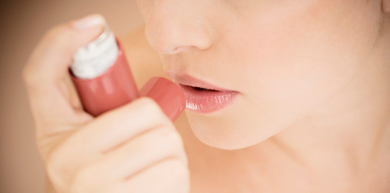 Female asthma sufferer using an inhaler --- Image by © I Love Images/Corbis