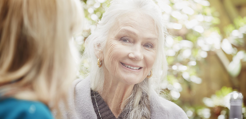 30 Mar 2015, London, England, UK --- Senior woman with grey hair in garden, portrait --- Image by © Phillip Waterman/Corbis