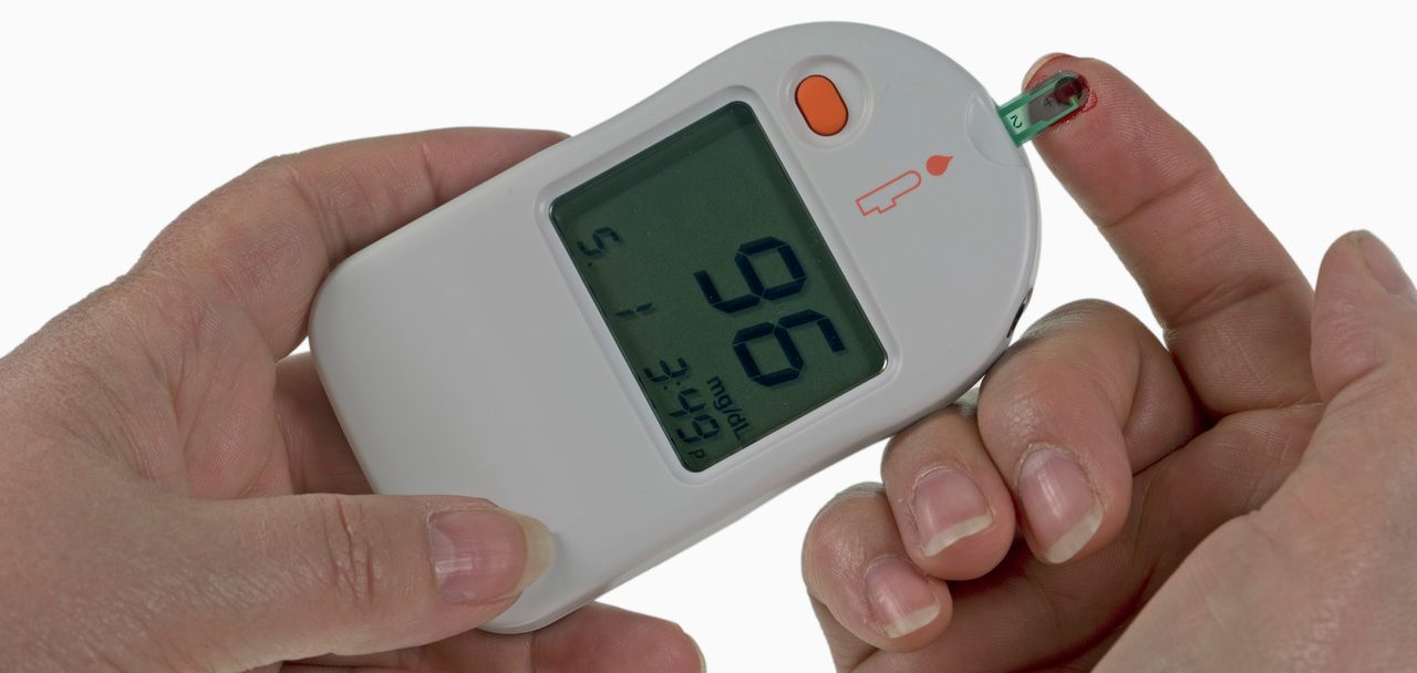 Woman Testing Her Blood Sugar --- Image by © Visuals Unlimited/Corbis