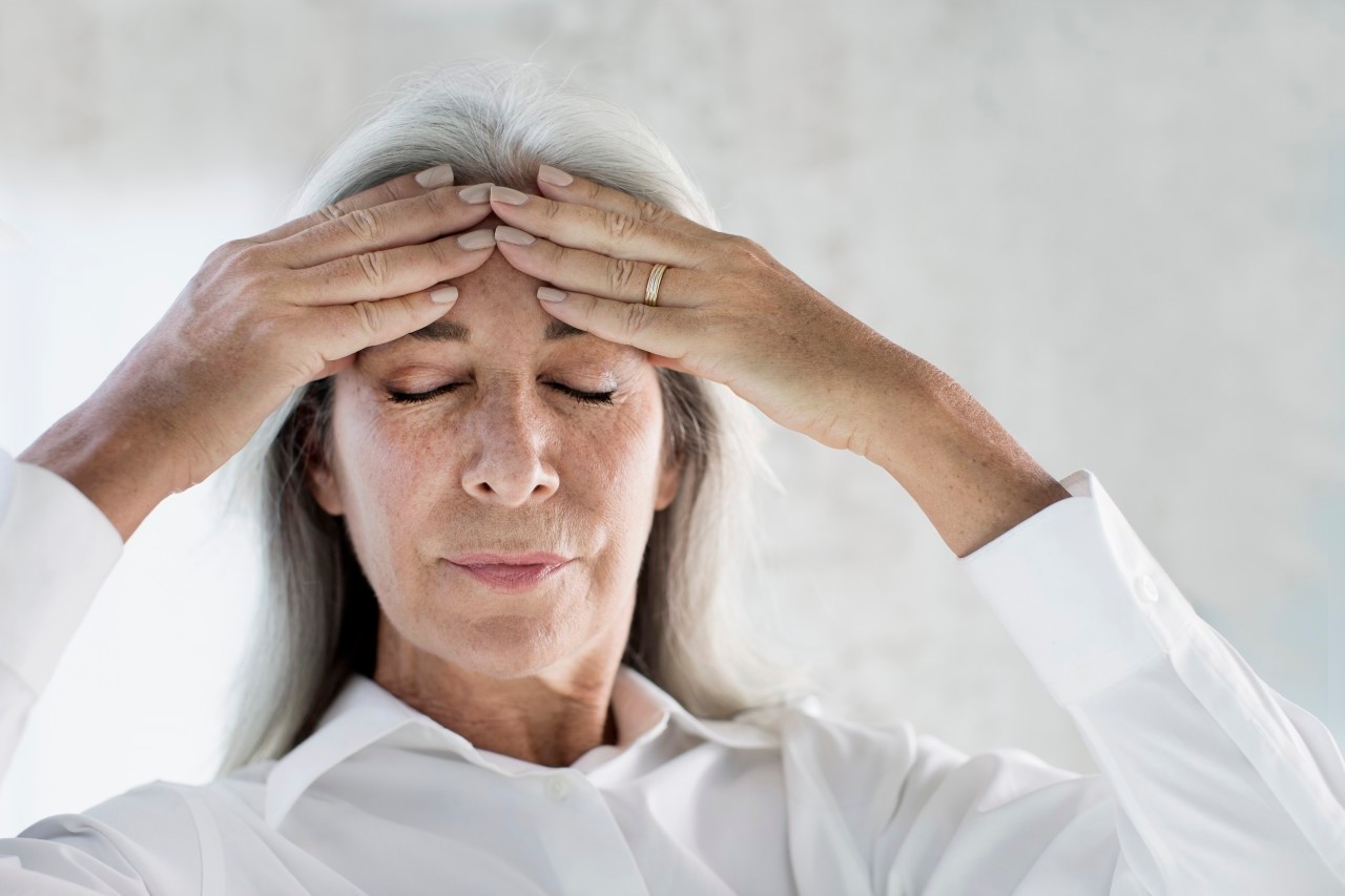 19 Feb 2015 --- Portrait of mature woman meditating with hands on forehead --- Image by © Gary John Norman/Corbis