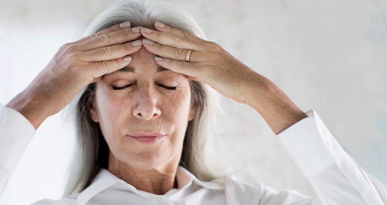 19 Feb 2015 --- Portrait of mature woman meditating with hands on forehead --- Image by © Gary John Norman/Corbis