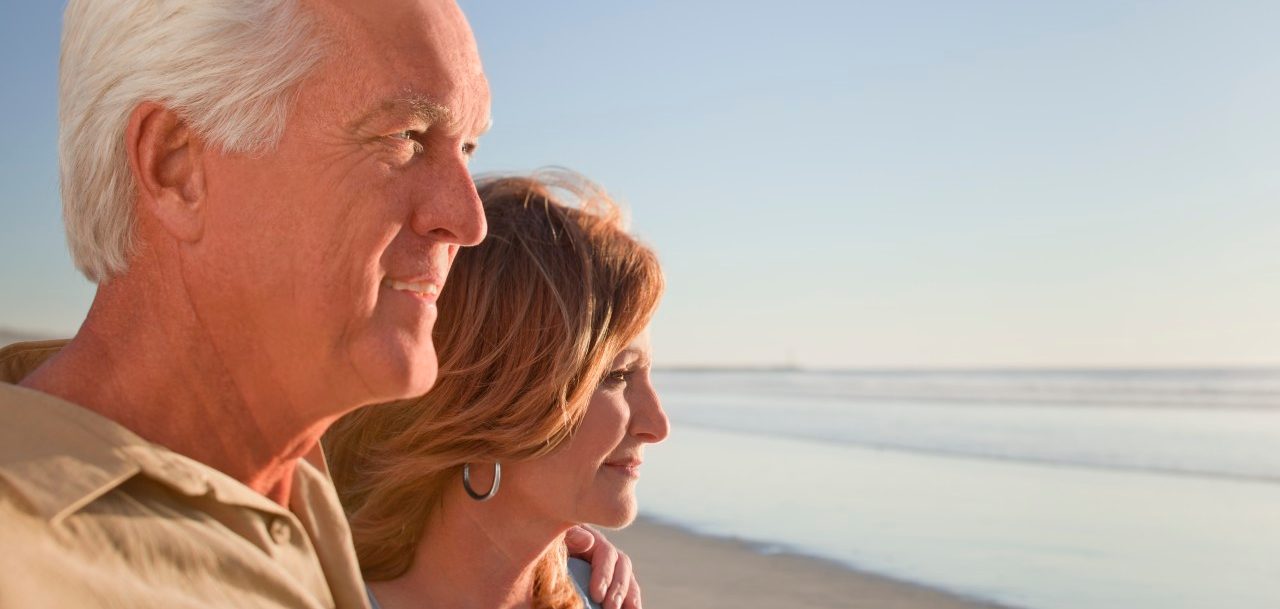 Middle aged couple on beach --- Image by © Patrick Lane/Corbis