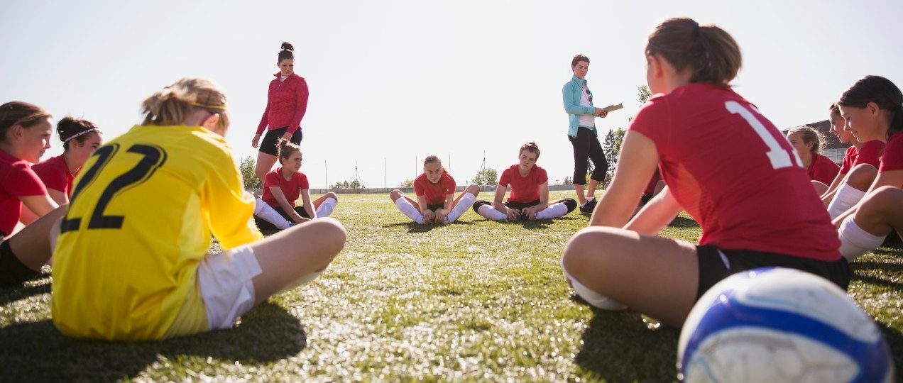 21 Sep 2012 --- Girls soccer team stretching before game. --- Image by © Hero Images/Corbis