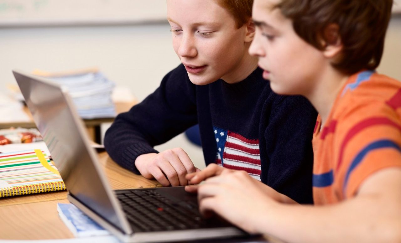 29 Nov 2013 --- High school boys using laptop at desk in classroom --- Image by © Maskot/Corbis