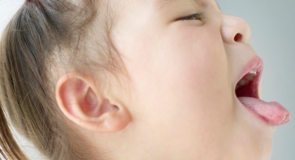 Coughing Young Girl --- Image by © Bloomimage/Corbis