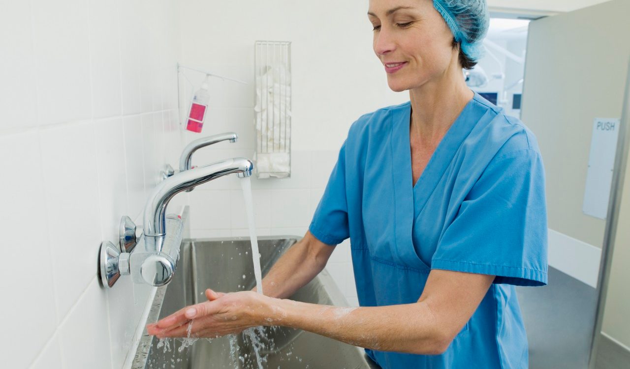 Surgeon washing hands before operation --- Image by © 237/Chris Ryan/Ocean/Corbis