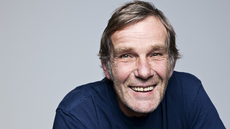 Studio portrait of senior man smiling --- Image by © Norbert Schaefer/Corbis