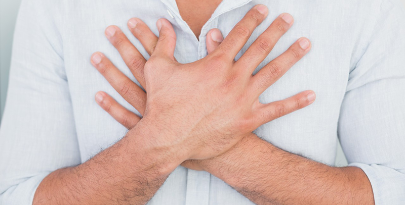 01 Aug 2013 --- Mid section of man with chest pain --- Image by © Wavebreak Media LTD/LightWave/Corbis