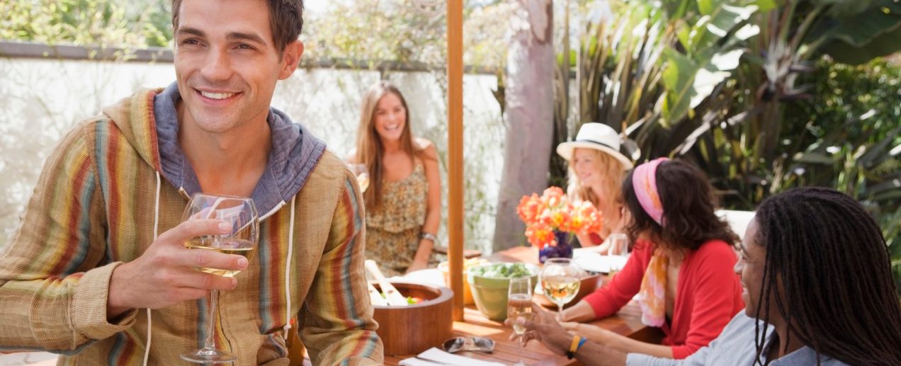 Friends dining at outdoor table --- Image by © Laura Doss/Corbis