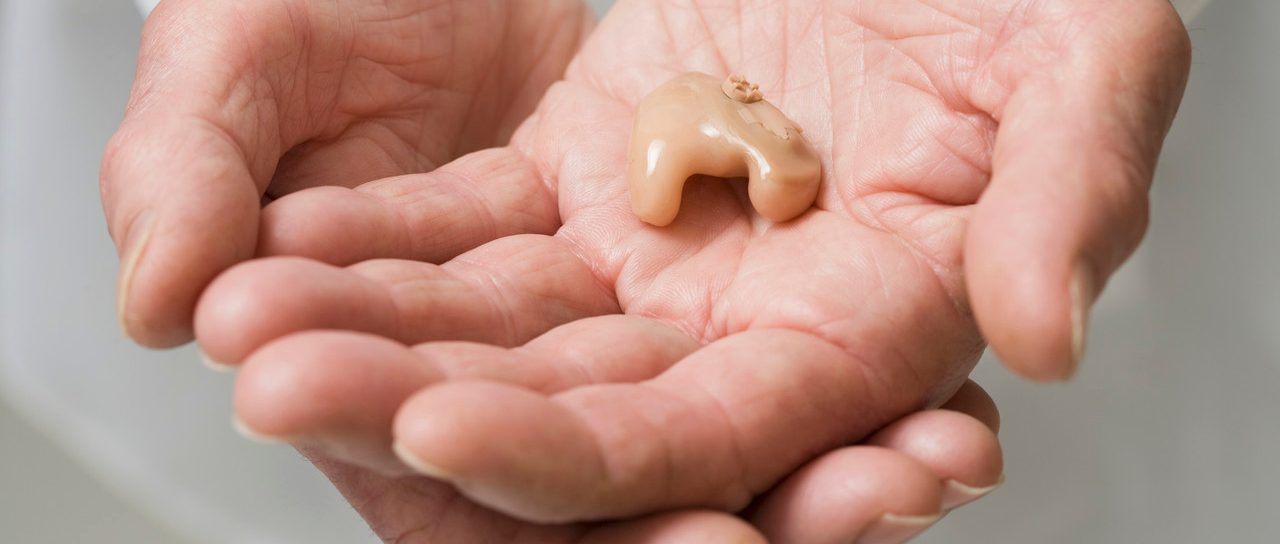 Close up of senior Hispanic man's hearing aid --- Image by © Jose Luis Pelaez, Inc./Blend Images/Corbis