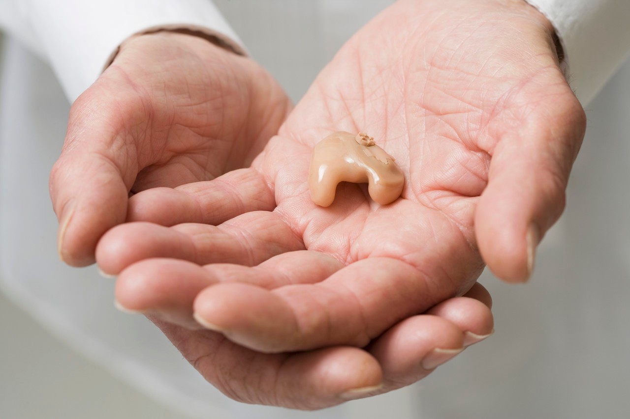 Close up of senior Hispanic man's hearing aid --- Image by © Jose Luis Pelaez, Inc./Blend Images/Corbis