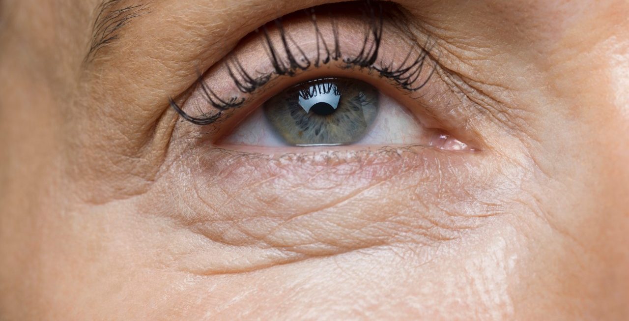 Studio shot of middle-aged woman, Detail of face with human eye --- Image by © James Lightbown/London, 2014/Corbis