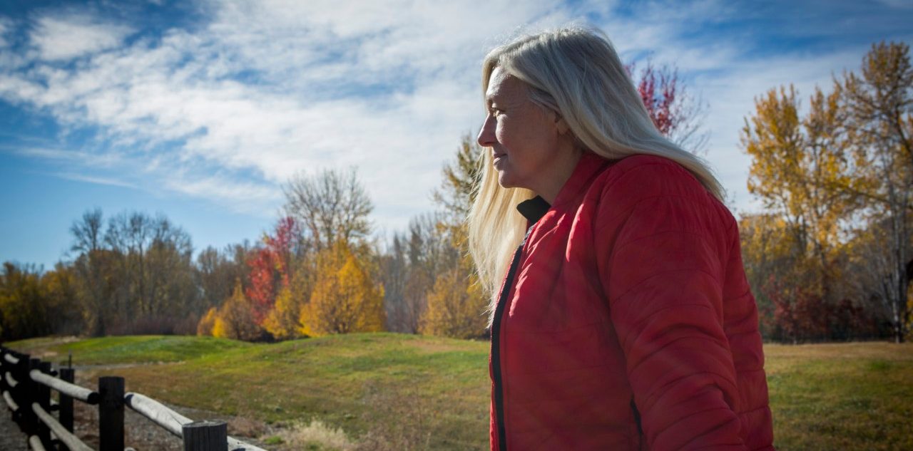 25 Oct 2014 --- Older Caucasian woman sitting on wooden fence --- Image by © Steve Smith/Blend Images/Corbis