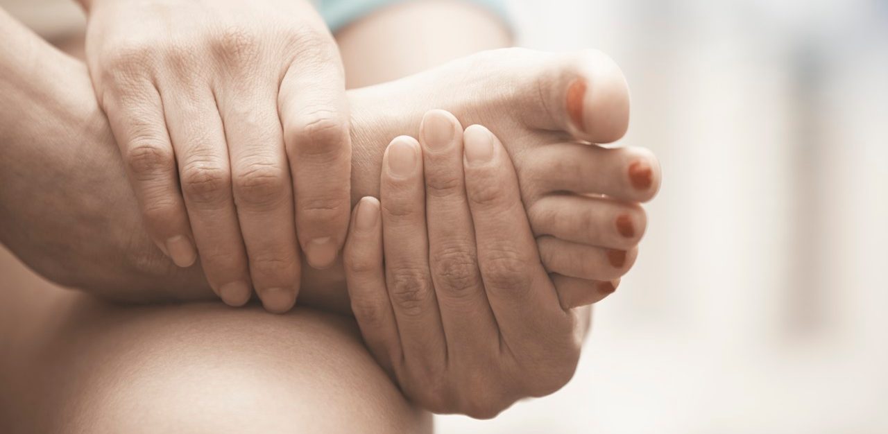 01 Feb 2015 --- Woman feeling foot pain. Close-up horizontal view --- Image by © Arman Zhenikeyev/Corbis