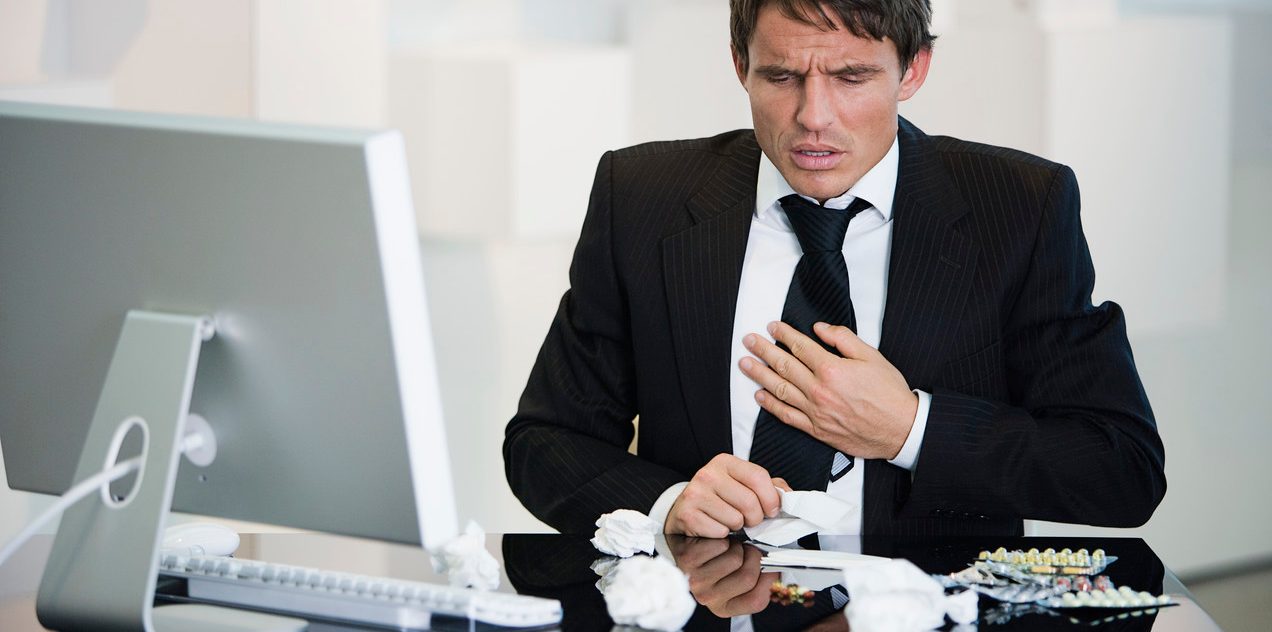 Businessman feeling sick --- Image by © HBSS/Corbis