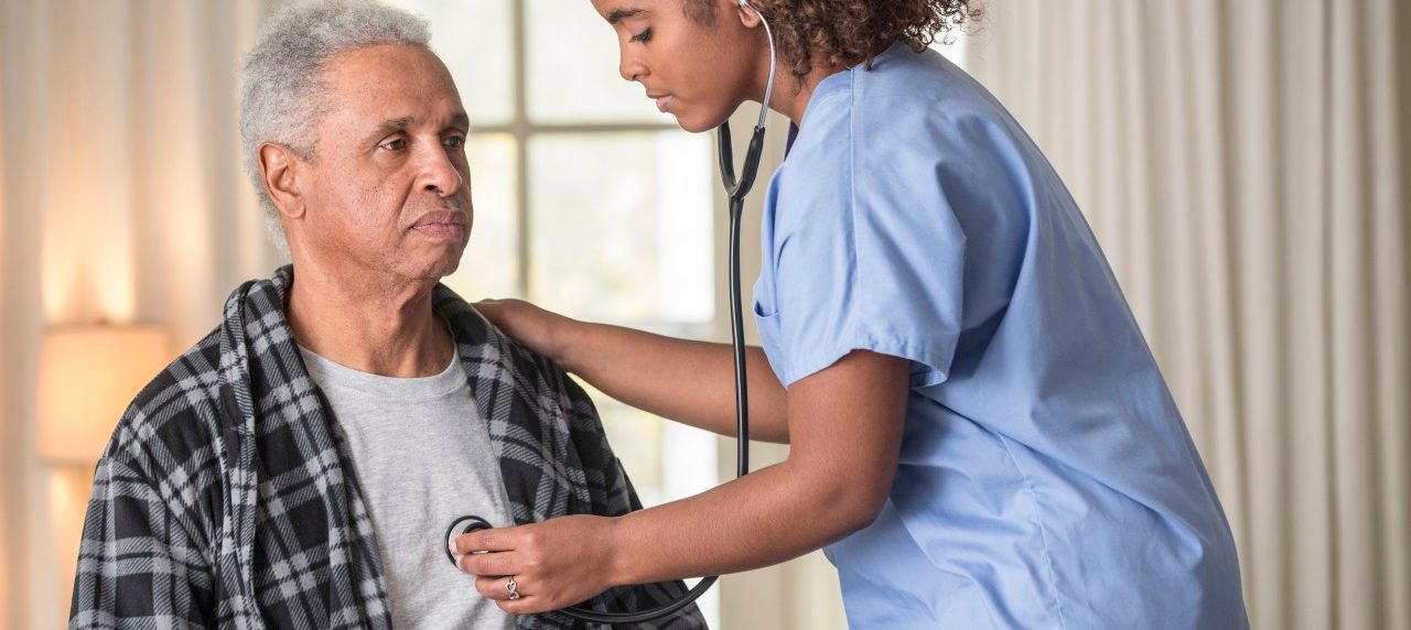 12 Dec 2013 --- African American nurse listening to Senior patient's heartbeat --- Image by © Terry Vine/Blend Images/Corbis