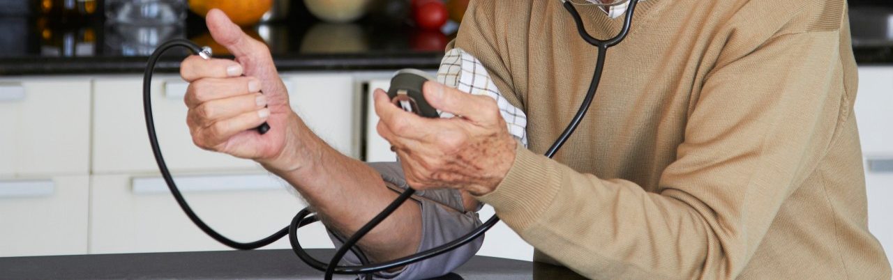 16 Dec 2011 --- Caucasian man taking his own blood pressure --- Image by © Rolf Bruderer/Blend Images/Corbis