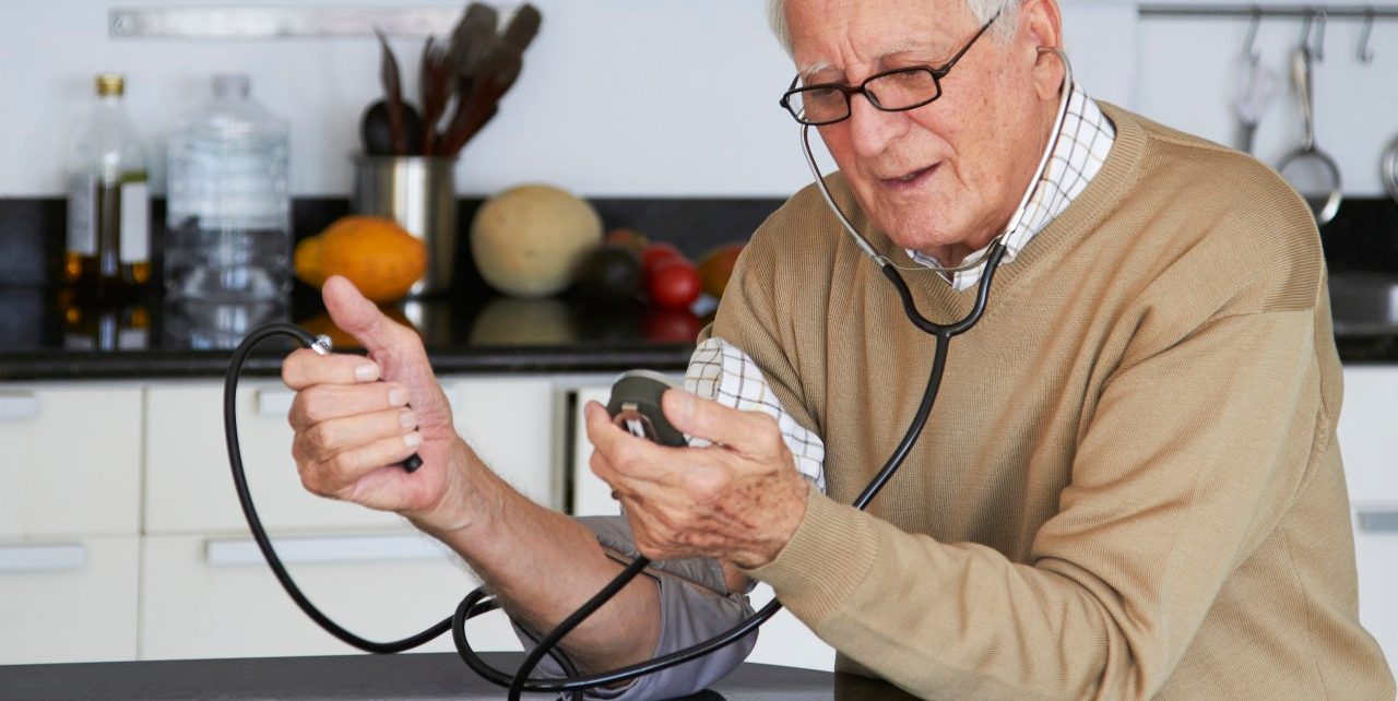 16 Dec 2011 --- Caucasian man taking his own blood pressure --- Image by © Rolf Bruderer/Blend Images/Corbis