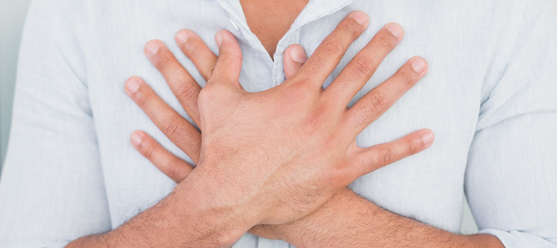 01 Aug 2013 --- Mid section of man with chest pain --- Image by © Wavebreak Media LTD/LightWave/Corbis