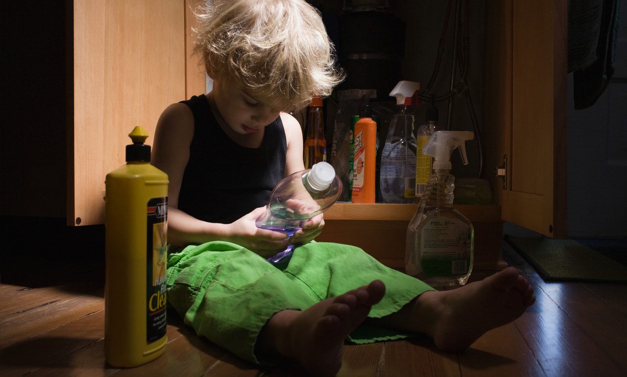 Little boy with cleaning products --- Image by © Image Source/Corbis