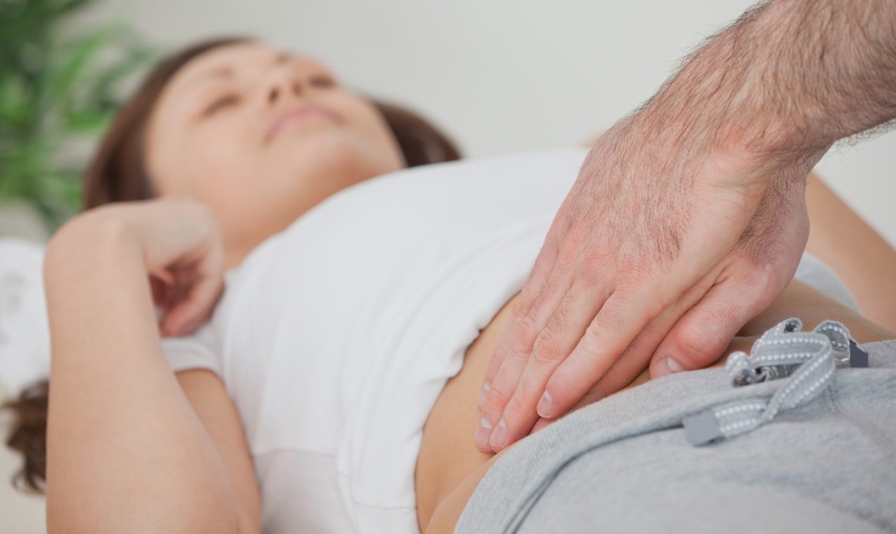 Ireland --- Doctor examining the stomach of his patient --- Image by © Wavebreak Media LTD/Wavebreak Media Ltd./Corbis