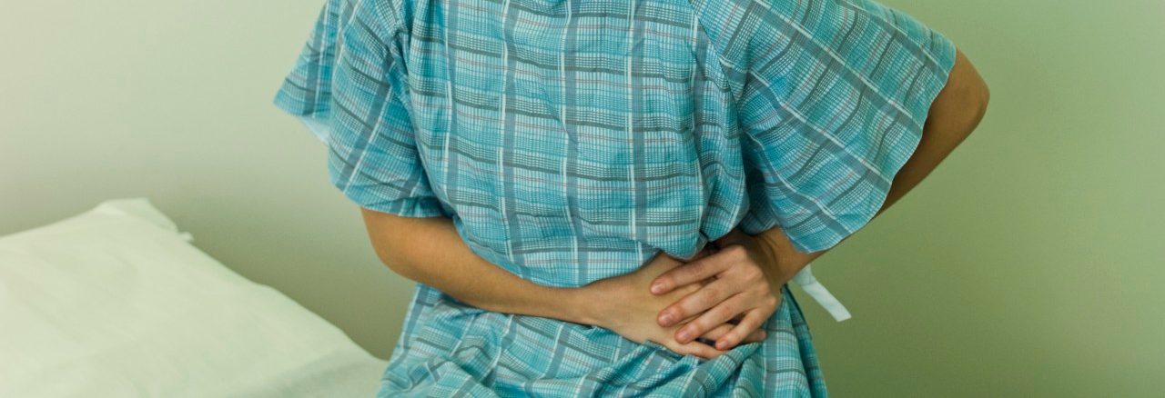 0042-11-30T00:00:00.000Z Female patient experiencing severe abdominal pain --- Image by © Michele Constantini/PhotoAlto/Corbis