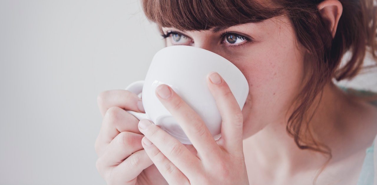 0042-11-30T00:00:00.000Z Young woman drinking tea --- Image by © Hannah Mentz/Corbis