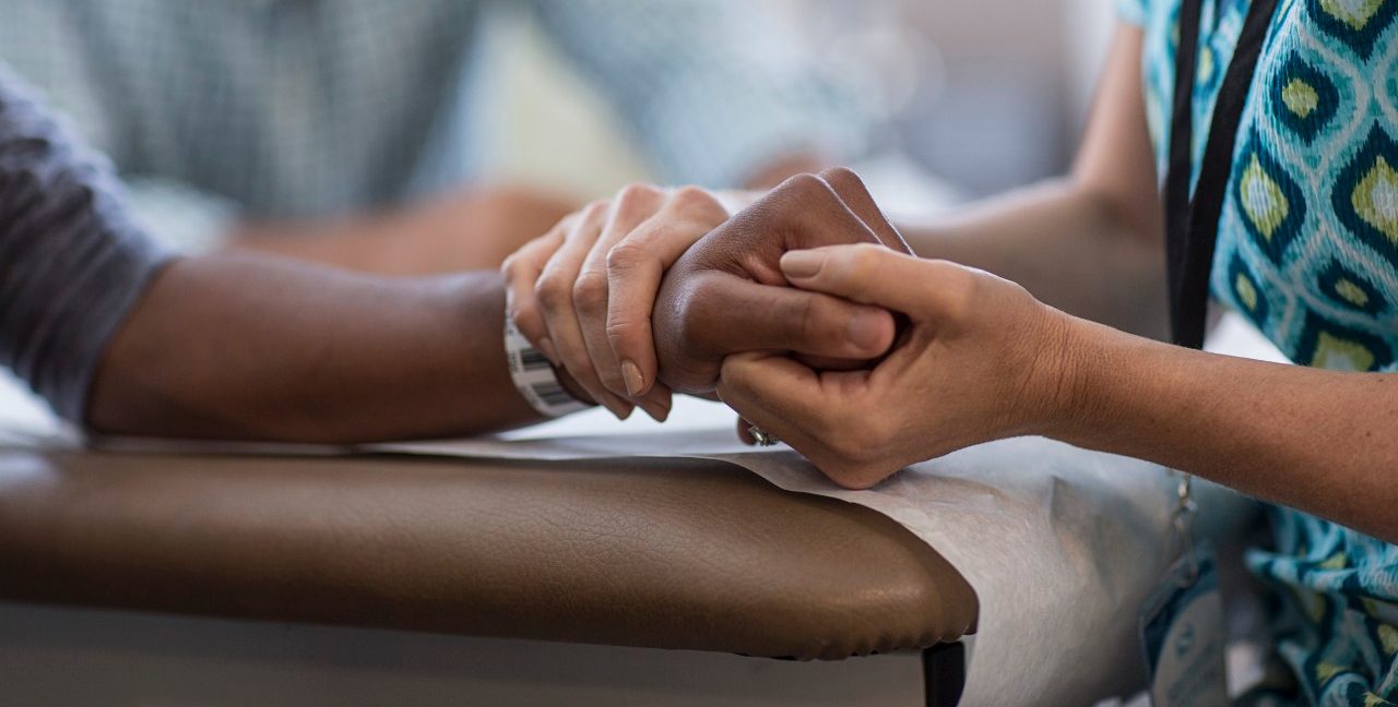 Nurse exercising boy's arm --- Image by © Isaac Lane Koval/Corbis