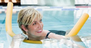 Woman with float in swimming pool