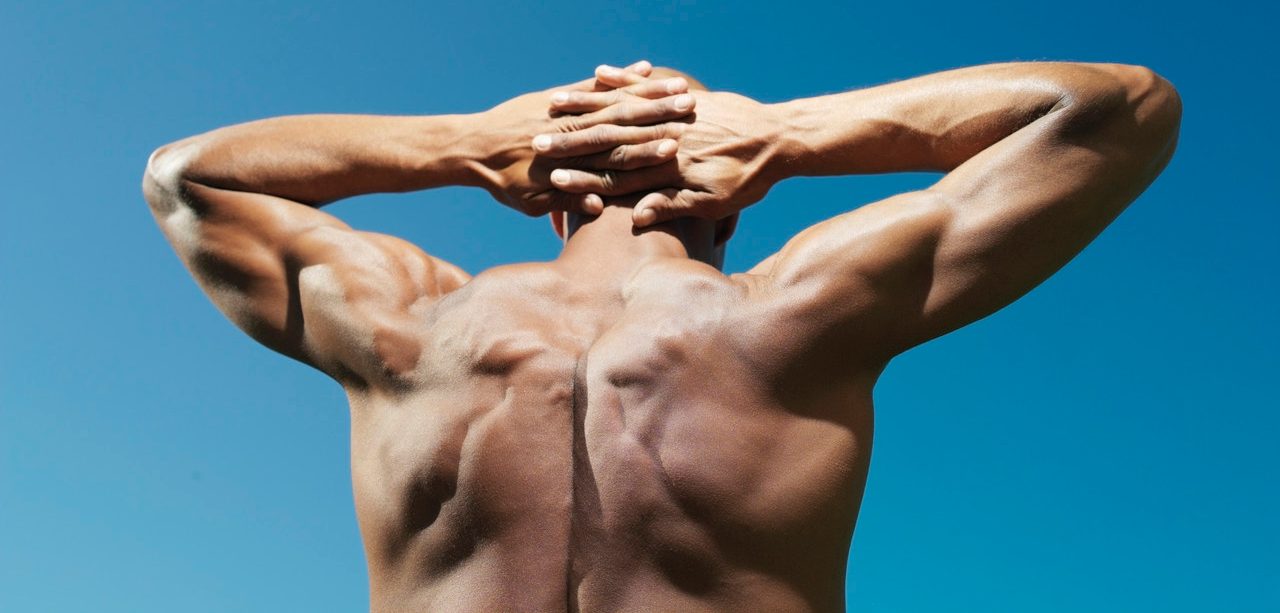 Muscular man with hands behind head --- Image by © Bernd Vogel/Corbis