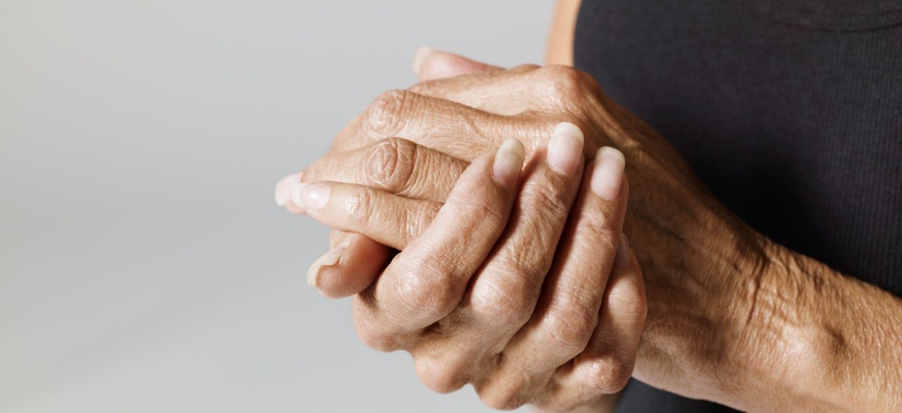 Woman with hands together --- Image by © Mark Weiss/Corbis