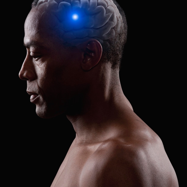 Blue light shining from brain of mixed race man