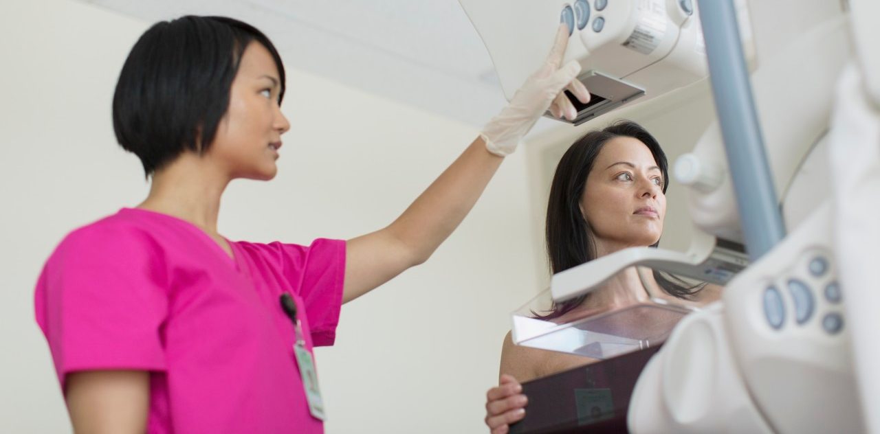 17 Jul 2012 --- Technician with patient having a mammograph. --- Image by © Hero Images/Corbis