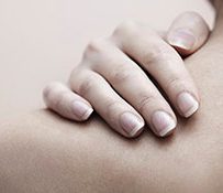 07 Oct 2012 --- Woman hand massaging shoulder --- Image by Â© Arman Zhenikeyev/Corbis