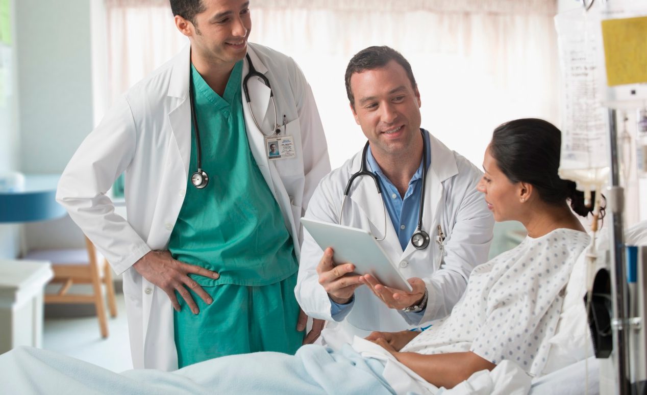 22 Jul 2013 --- Doctor and nurse talking to patient in hospital --- Image by © Jose Luis Pelaez Inc/Blend Images/Corbis