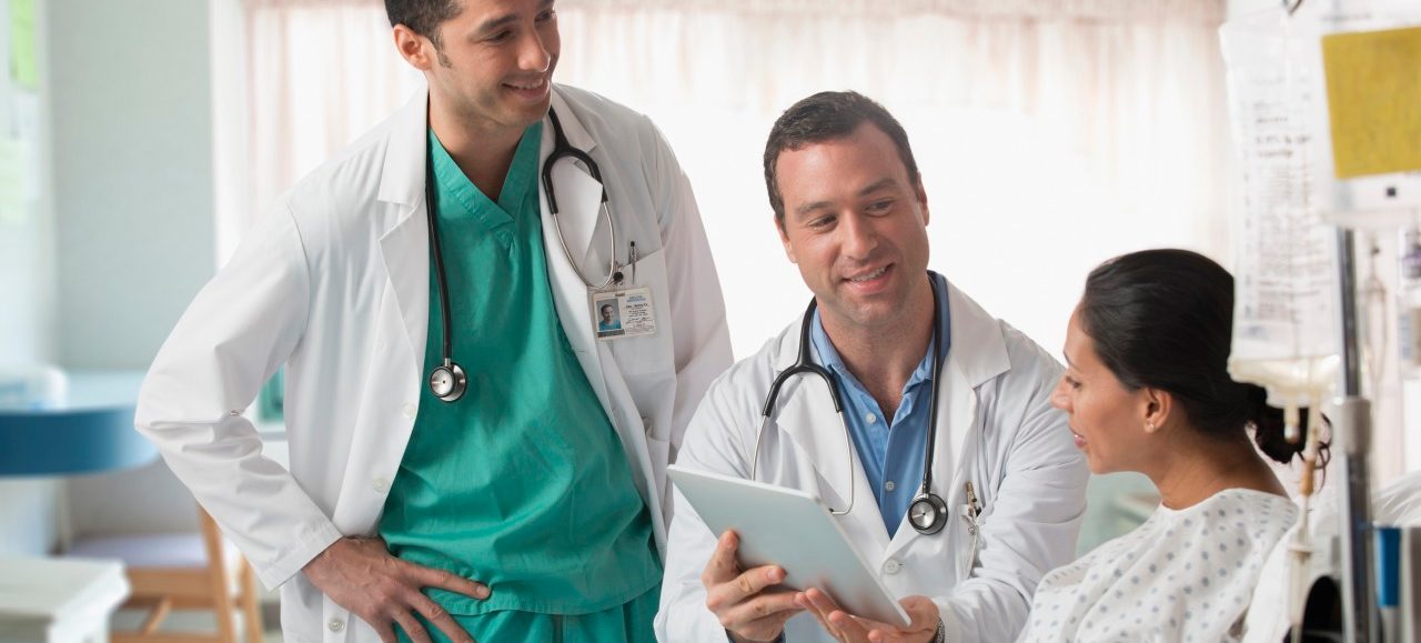 22 Jul 2013 --- Doctor and nurse talking to patient in hospital --- Image by © Jose Luis Pelaez Inc/Blend Images/Corbis