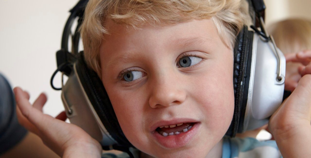 31 Jan 2015 --- Little boy listening to music with headphones --- Image by © Rainer Holz/Westend61/Corbis