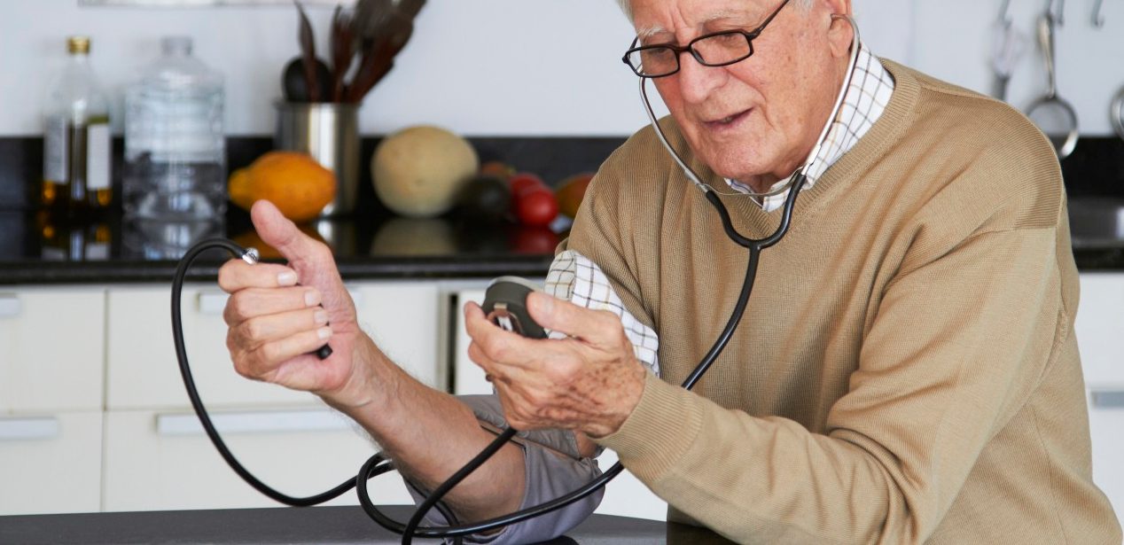 16 Dec 2011 --- Caucasian man taking his own blood pressure --- Image by © Rolf Bruderer/Blend Images/Corbis