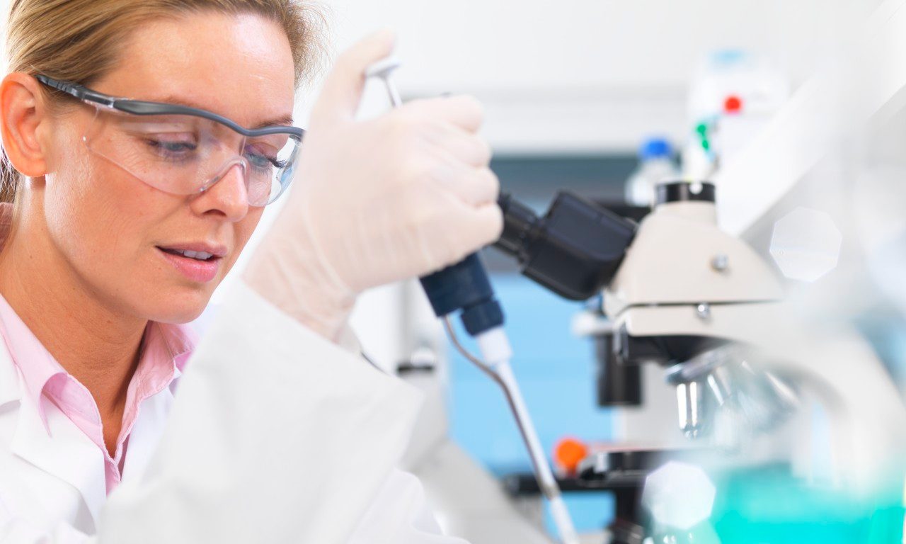 Scientist pipetting sample into phial for analytical testing --- Image by © Andrew Brookes/Corbis