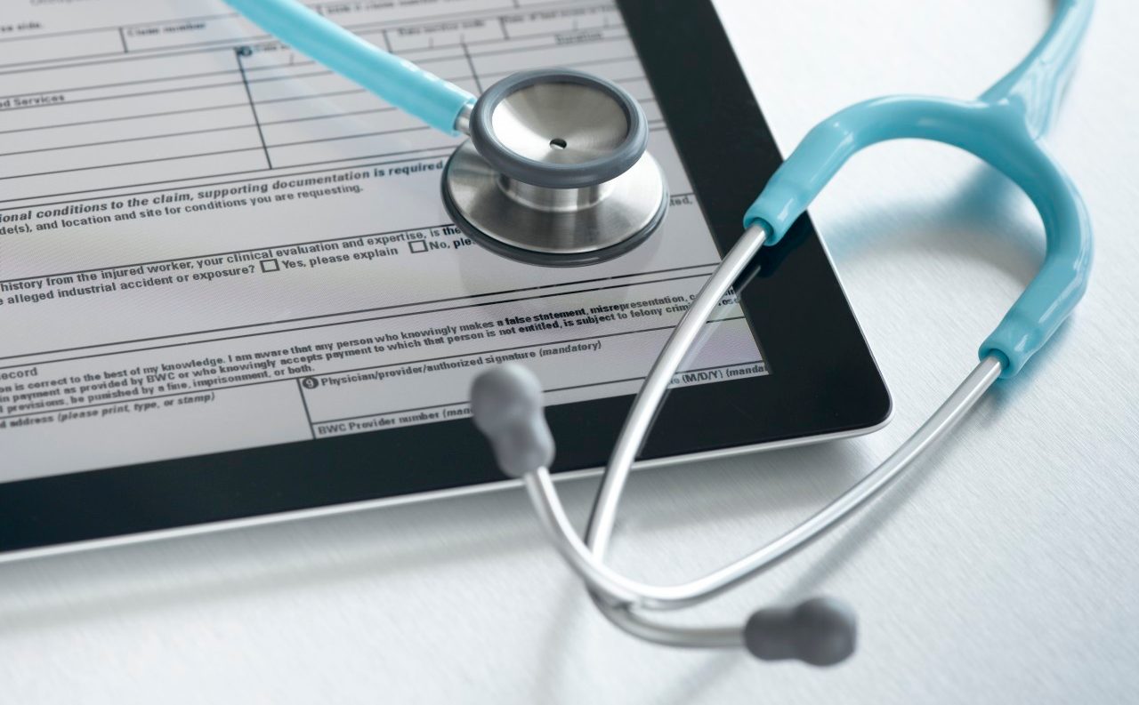 Studio shot of stethoscope and digital tablet with medical form --- Image by © Pulse/Corbis