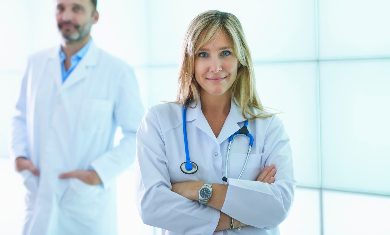 31 Oct 2014 --- Doctors posing against backlit wall panel --- Image by © Corbis