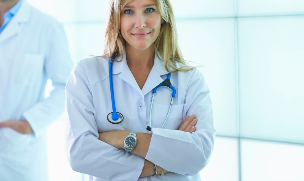 31 Oct 2014 --- Doctors posing against backlit wall panel --- Image by © Corbis