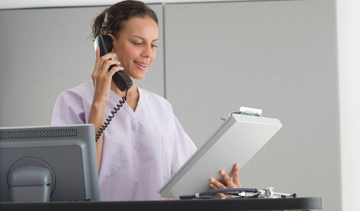 Medical Staff Telephoning About Medical Chart --- Image by © Tom Grill/Corbis