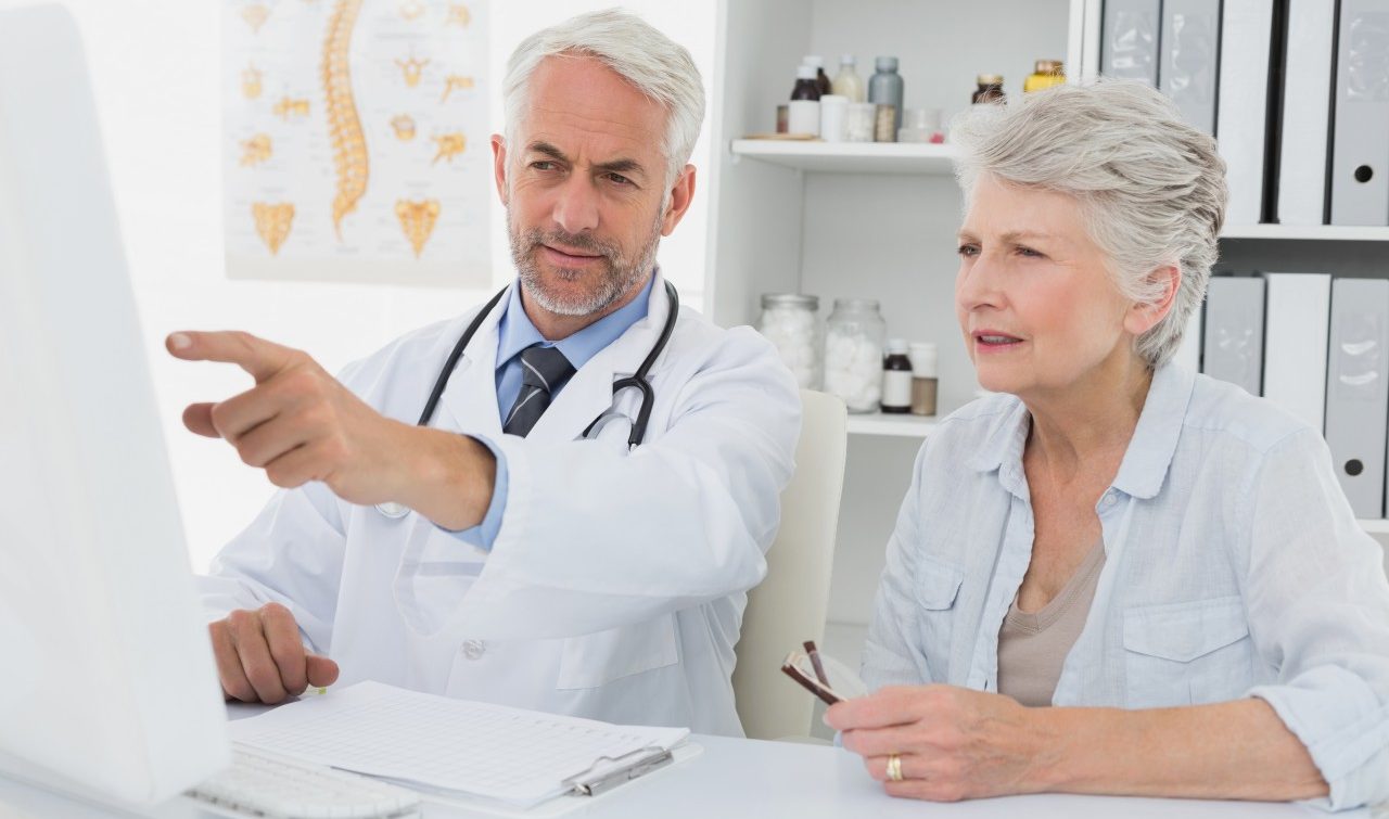 22 Nov 2013 --- Doctor with female patient reading reports on computer --- Image by © Wavebreak Media LTD/Wavebreak Media Ltd./Corbis