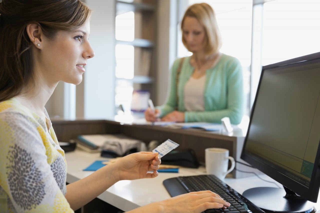 09 Mar 2014 --- Receptionist inputting insurance information at computer --- Image by © Hero Images Inc./Hero Images Inc./Corbis