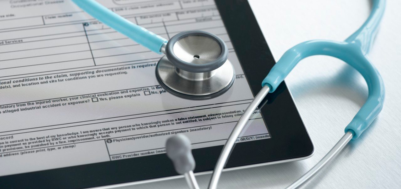 Studio shot of stethoscope and digital tablet with medical form --- Image by © Pulse/Corbis